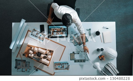 Top view of smart business man using tablet planning house design. Alimentation. 130480228