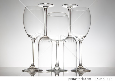 Five refined wine glasses with varied designs, their reflections shimmering Five refined wine glasses with varied designs, their reflections shimmering 130480448