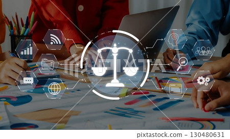 Business team collaborating on a legal project with digital scales symbolizing justice over paperwork and technology background in a modern workspace. Raster 130480631