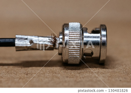 Macro photo of BNC connector. Metal connector with central contact, used for coaxial cables in video communication and radio equipment. BNC connector crimping. 130481826