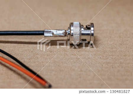 Macro photo of BNC connector. Metal connector with central contact, used for coaxial cables in video communication and radio equipment. BNC connector crimping. 130481827