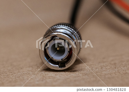 Macro photo of BNC connector. Metal connector with central contact, used for coaxial cables in video communication and radio equipment. BNC connector crimping. 130481828
