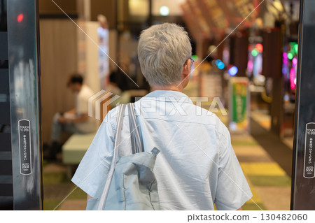 Men playing at a pachinko parlor 130482060