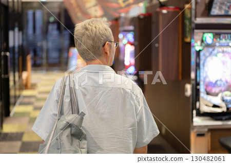 Men playing at a pachinko parlor 130482061