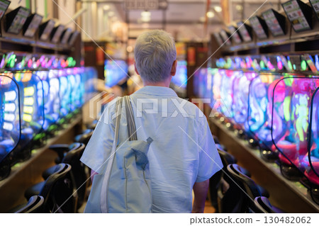Men playing at a pachinko parlor Men playing at a pachinko parlor 130482062