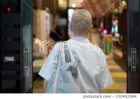 Men playing at a pachinko parlor 130482064