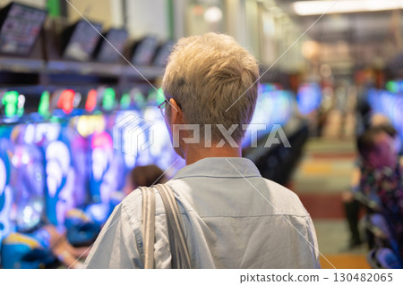 Men playing at a pachinko parlor 130482065
