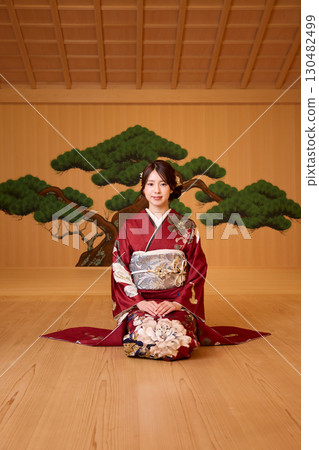 Japanese woman in furisode kimono standing on the Noh stage 130482499