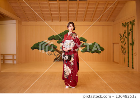 Japanese woman in furisode kimono standing on the Noh stage 130482532