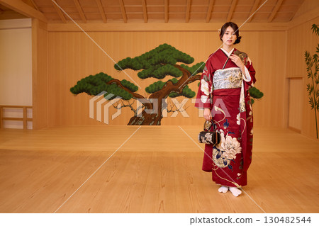 Japanese woman in furisode kimono standing on the Noh stage Japanese woman in furisode kimono standing on the Noh stage 130482544