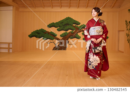 Japanese woman in furisode kimono standing on the Noh stage 130482545