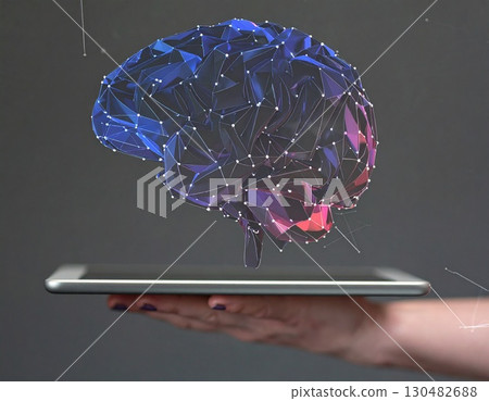 Digital Brain Innovation: A hand gracefully holds a digital tablet, from which a luminous, intricately designed brain composed of interconnected nodes and lines emerges. 130482688