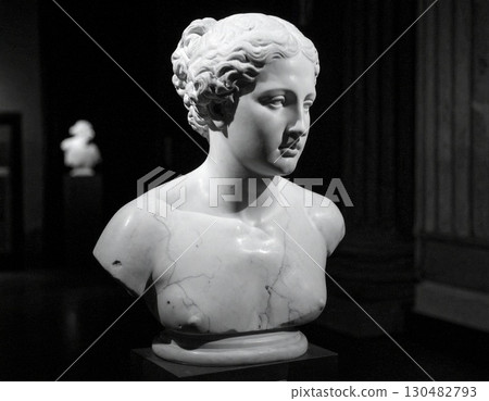 A cracked statue's delicate face evokes a sense of history and fragility A cracked statue's delicate face evokes a sense of history and fragility 130482793