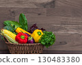 A harvest of season vegetables. Fresh organic vegetables in wicker basket. Close up of Assorted fresh vegetables on wooden background. Healthy food. Copy space, nobody. Set of different vegetables 130483380