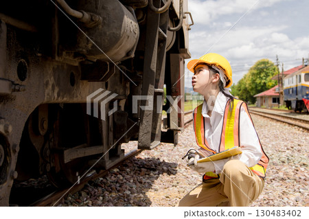 Asian young teen engineer worker work in Train station, Old locomotive service maintenance 130483402