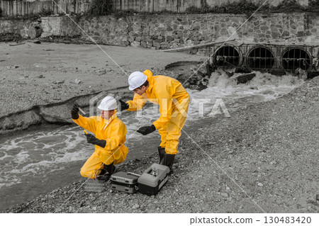 Water Pollution Control. Scientist team checking water quality from industry wastewater sewage river impact from danger toxic and chemical release 130483420
