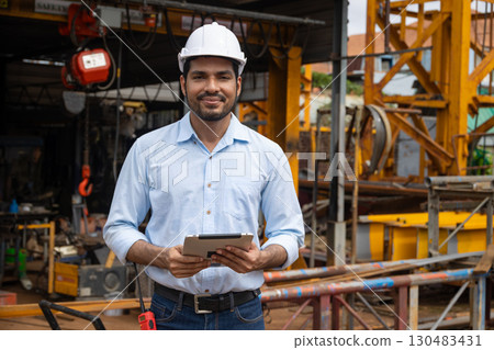 Portrait Hispanic Indian construction engineer male worker at construction site with safety hard hat 130483431