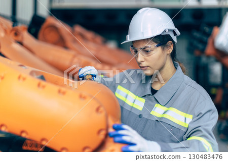 Engineer woman working in machine factory. Indian female engineer work in robot arm assembly plant Engineer woman working in machine factory. Indian female engineer work in robot arm assembly plant 130483476