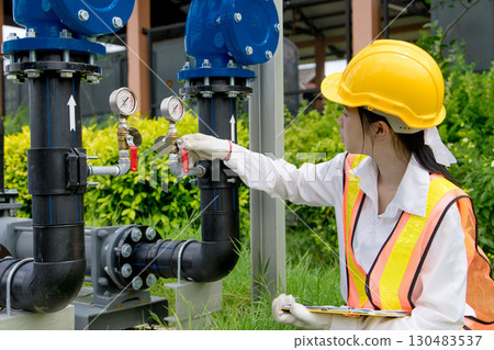 Engineer technician check new install progressing cavity pumps and water valve pipe system outdoor 130483537