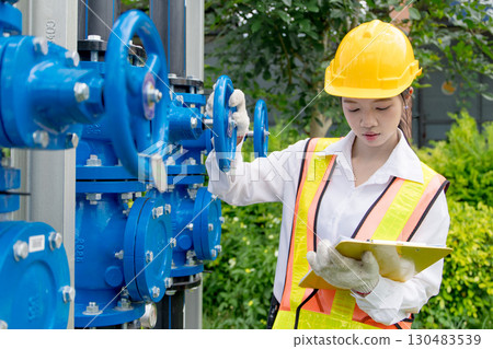 Engineer technician check new install progressing cavity pumps and water valve pipe system outdoor 130483539