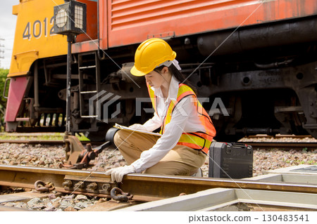 Asian young teen train engineer work check inspect service maintenance old locomotive railway track Asian young teen train engineer work check inspect service maintenance old locomotive railway track 130483541
