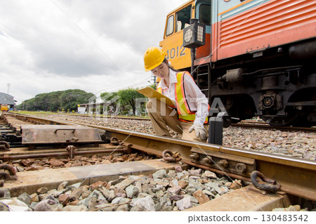 Asian young teen train engineer work check inspect service maintenance old locomotive railway track Asian young teen train engineer work check inspect service maintenance old locomotive railway track 130483542