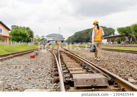 Asian young teen train engineer work check inspect service maintenance old locomotive railway track Asian young teen train engineer work check inspect service maintenance old locomotive railway track 130483544