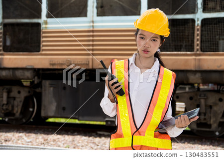 Portrait Asian young teen engineer worker work in Train station, Locomotive service station Portrait Asian young teen engineer worker work in Train station, Locomotive service station 130483551