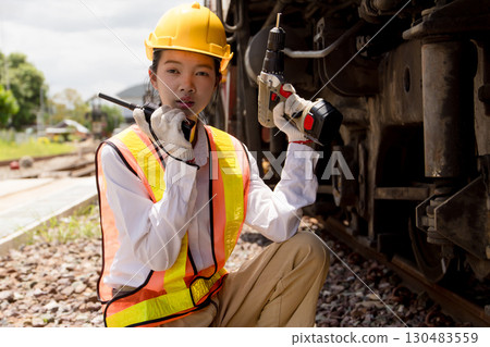 Asian young teen engineer worker work in Train station, Old locomotive service maintenance 130483559