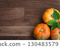 Thanksgiving season still life with colorful small pumpkins. Autumn orange pumpkins on wooden table background. Halloween concept , top view, copy space. Seasonal, harvest, fall, organic food concept 130483579