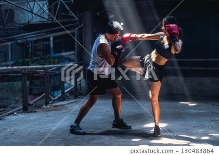 Thai boxing, Women fighter training kick boxing with trainer in ruin building ,Asian martial arts 130483864