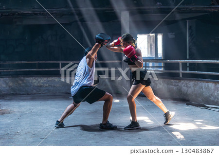 Thai boxing, Women fighter training kick boxing with trainer in ruin building ,Asian martial arts 130483867