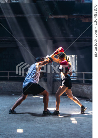 Thai boxing, Women fighter training kick boxing with trainer in ruin building ,Asian martial arts 130483870