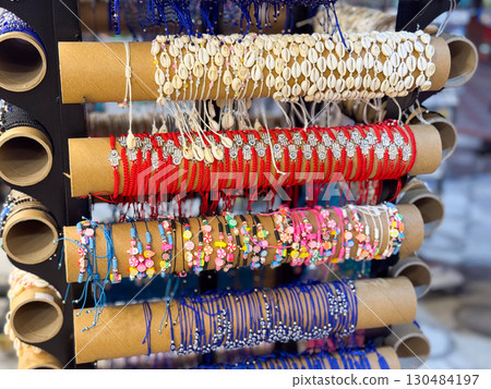 Colorful bead bracelets on market stand. Fashion, craft, and handmade accessories for personal style. Colorful bead bracelets on market stand. Fashion, craft, and handmade accessories for personal style. 130484197