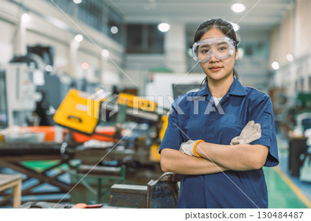 Smart confident engineer worker standing portrait thumbs up in modern metal workshop plant factory 130484487