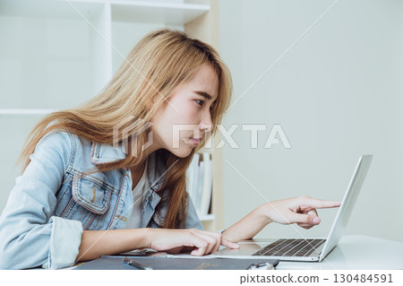 Young business women pay attention finger pointing reading close at computer laptop screen carefully 130484591