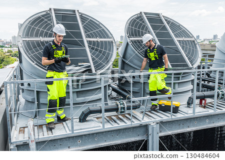 Professional engineer team service checking HVAC cooling tower, fan water Industry air conditioner Professional engineer team service checking HVAC cooling tower, fan water Industry air conditioner 130484604