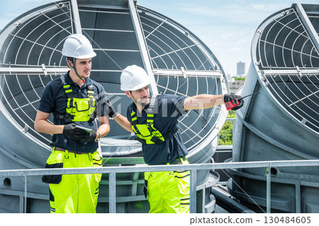 Professional engineer team service checking HVAC cooling tower, fan water Industry air conditioner 130484605