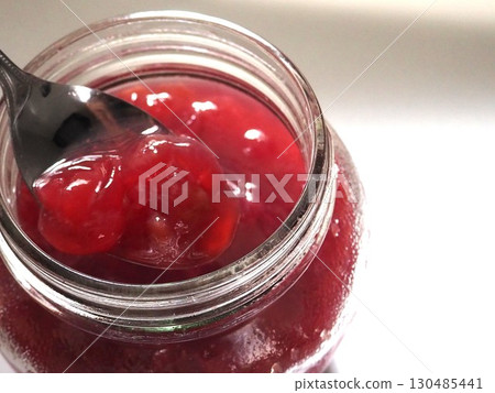 A photo of someone lifting grape compote from their chopsticks (from top to bottom, left-justified) A photo of someone lifting grape compote from their chopsticks (from top to bottom, left-justified) 130485441