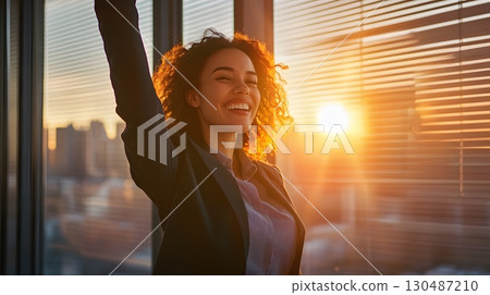 successful businesswoman celebrating success at sunset 130487210