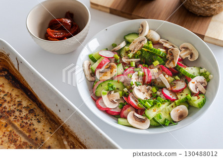 Healthy lunch: radish salad with baked fish 130488012