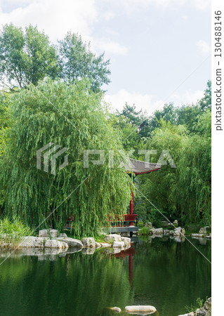 beautiful landscape of oriental garden with pond and gazebo among foliage, vertical frame beautiful landscape of oriental garden with pond and gazebo among foliage, vertical frame 130488146