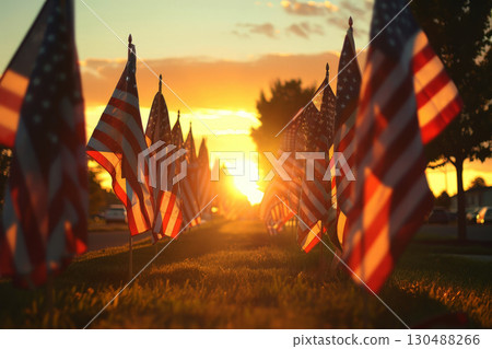 A row of USA flags standing in Remembrance on Memorial Day in the Unit amidst sunlight. 130488266