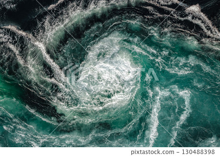 Blue waves of water of the river and the sea meet each other during high tide and low tide. Blue waves of water of the river and the sea meet each other during high tide and low tide. 130488398