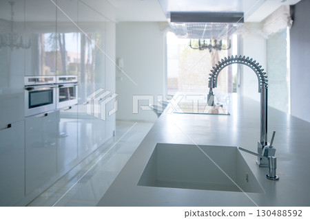 Modern white kitchen perspective with integrated bench Modern white kitchen perspective with integrated bench 130488592