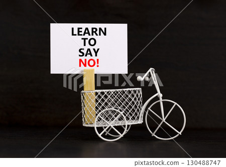 Learn to say no symbol. Concept words phrase Learn to say no on beautiful white paper on wooden clothespin. Beautiful black paper background. Business psychological Learn to say no concept Copy space Learn to say no symbol. Concept words phrase Learn to say no on beautiful white paper on wooden clothespin. Beautiful black paper background. Business psychological Learn to say no concept Copy space 130488747