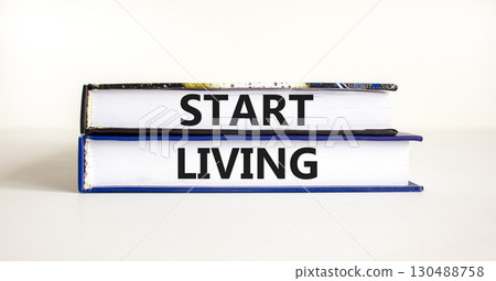 Start living symbol. Concept words Start living on beautiful books. Beautiful white table white background. Business and Start living concept. Copy space. 130488758