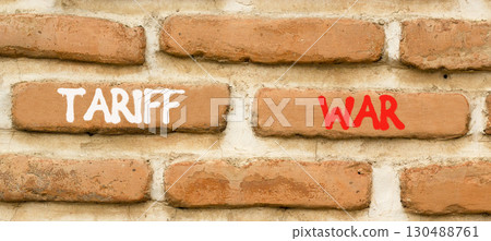 Trade tariff war symbol. Concept word Tariff war on beautiful old brown brick wall. Beautiful old brown brick wall background. Old brick wall. Business trade tariff wars concept. Copy space. 130488761