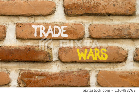 Trade wars symbol. Concept word Trade wars on beautiful old brown brick wall. Beautiful old brown brick wall background. Old brick wall. Business trade wars concept. Copy space. 130488762