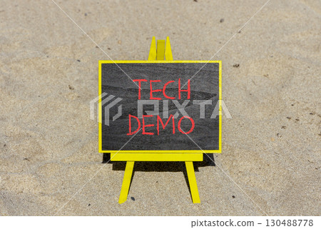 Tech demo symbol. Concept word Tech demo on beautiful black blackboard. Beautiful sand beach background. Black blackboard. Business tech demo concept. Copy space. 130488778
